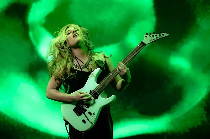 Guitarist Alyssa Day playing in front of an LED volume wall during a virtual production shoot for PreSonus Studio One Pro 7.2