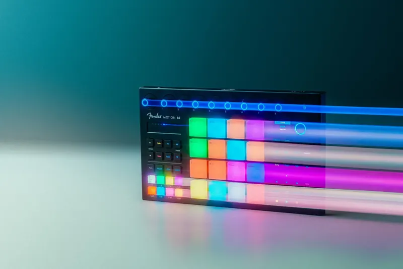 Fender Motion 16 pad controller lit with coloured light streaks against a deep teal backdrop