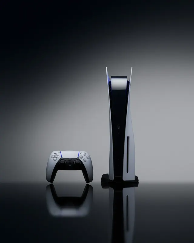 PlayStation 5 console spec product shot lit with blue and magenta studio light