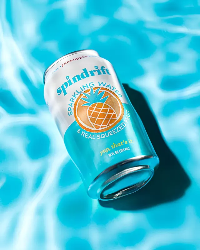 Spindrift sparkling water can spec product shot with splashing water and fruit