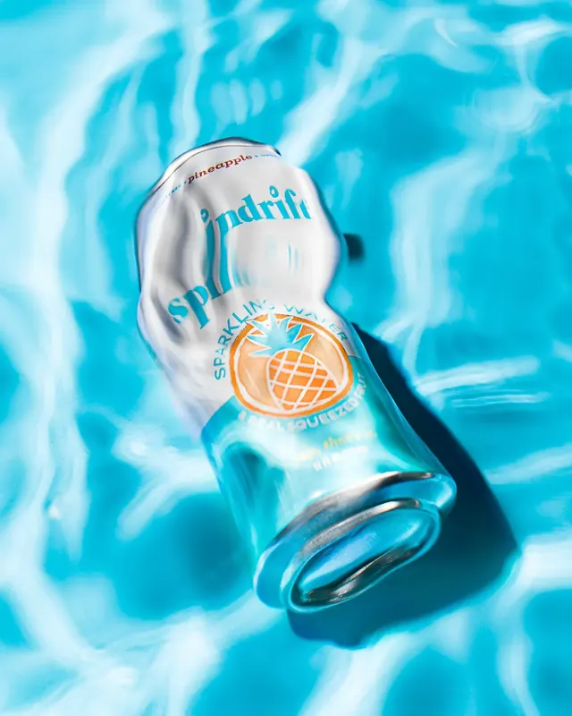Second Spindrift can product shot on a bright colour background with hard shadow