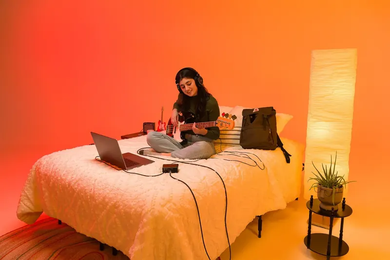 Musician recording with the PreSonus AudioBox GO in a compact home setup
